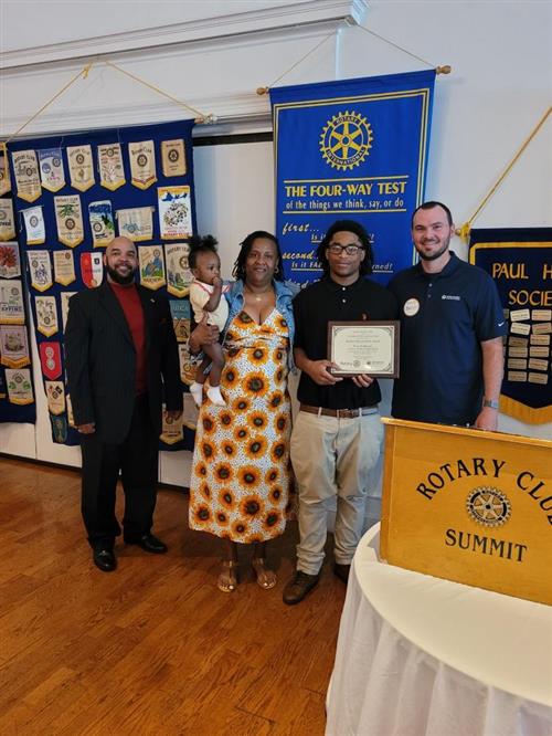 Tony Robinson, pictured with his family and Principal Rodney Boone is presented the Student Improvement Award 
