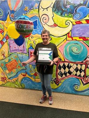 photo of Ms. Powers with certificate