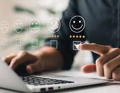  Person selecting the happiest smiley face on a digital feedback form with five rating options