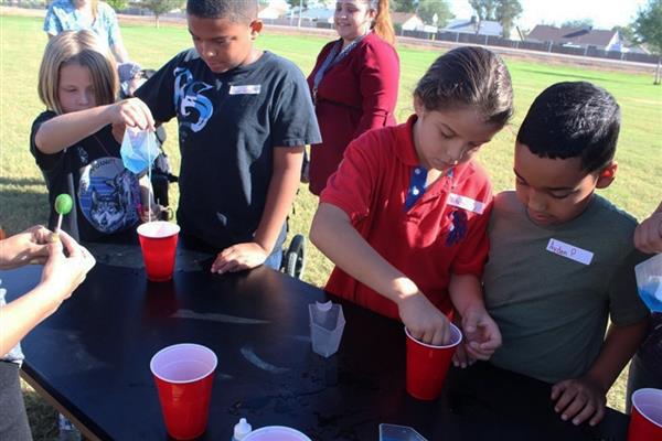 Children around table doing project Children around table doing project