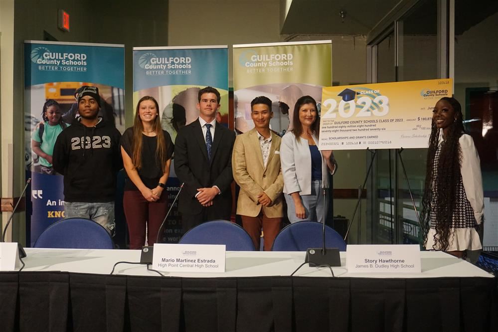  Picture of five GCS students with Superintendent Oakley near a large scholarship check