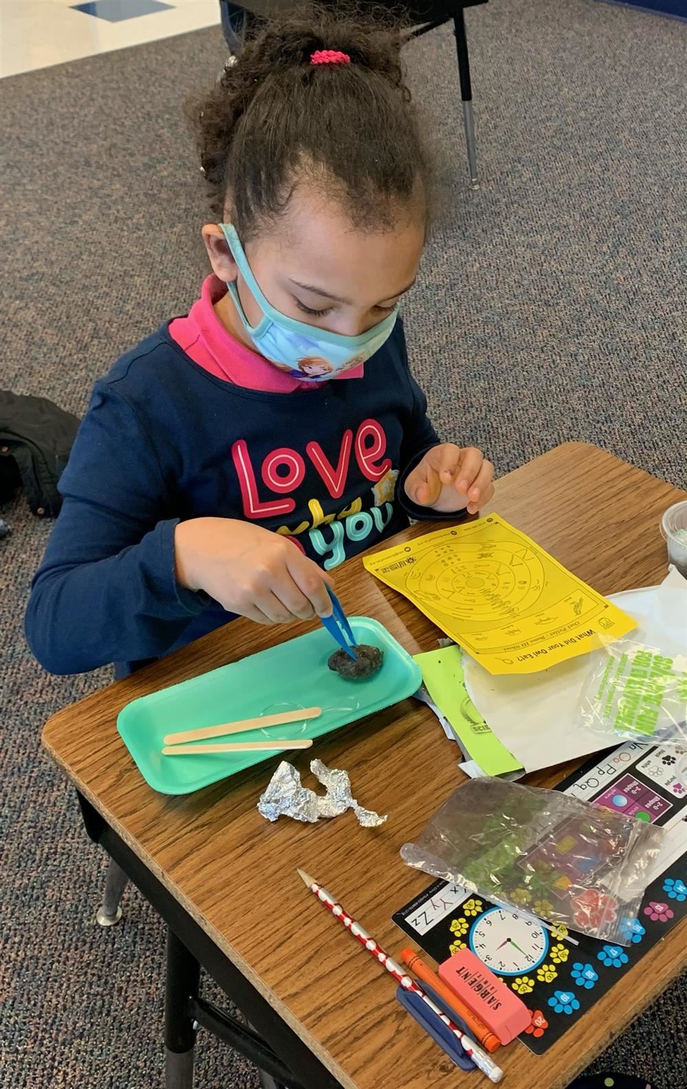 Student playing with the science is fun materials 