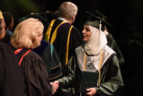 graduate shaking hands with board member 